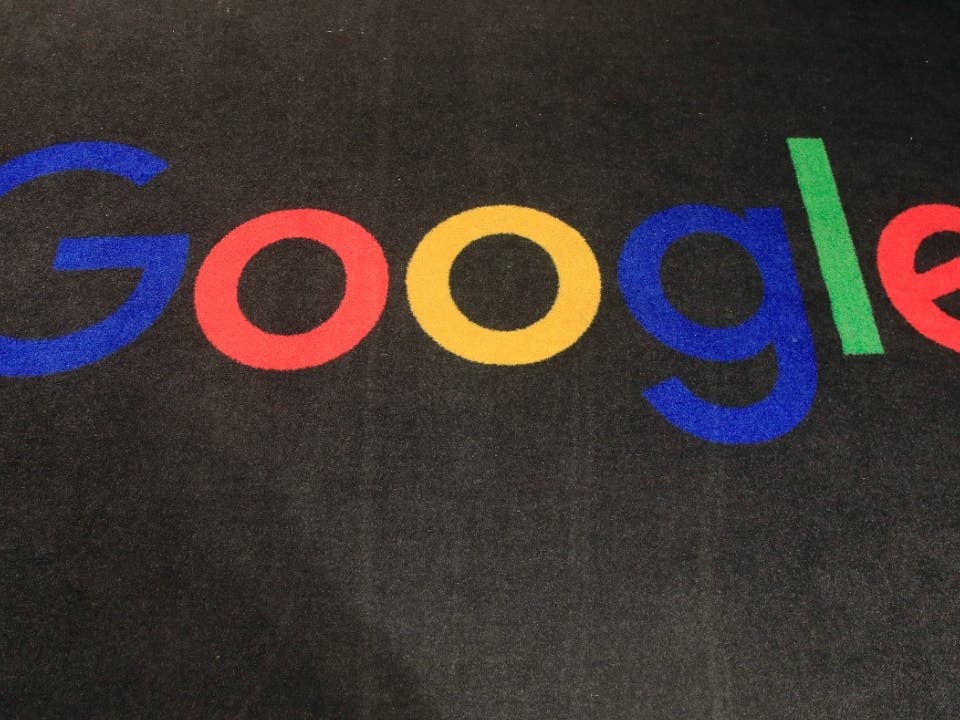 The logo of Google is displayed on a carpet at the entrance hall of Google. Google said Friday, jan. 20, 2023, it’s laying off 12,000 workers, becoming the latest tech company to trim staff after rapid expansions during the pandemic.