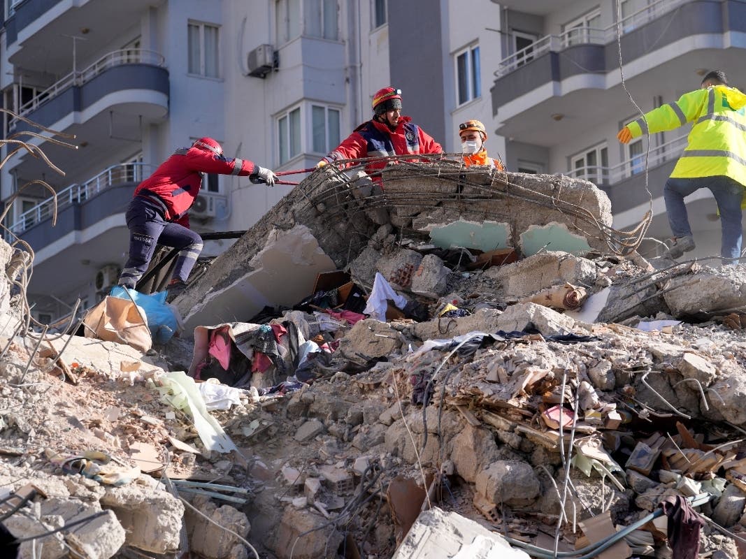 Emergency teams search for people in the rubble in a destroyed building in Adana, southern Turkey, Tuesday, Feb. 7, 2023. A search-and-rescue team from the Los Angeles County Fire Department on Monday was being deployed to help find survivors.