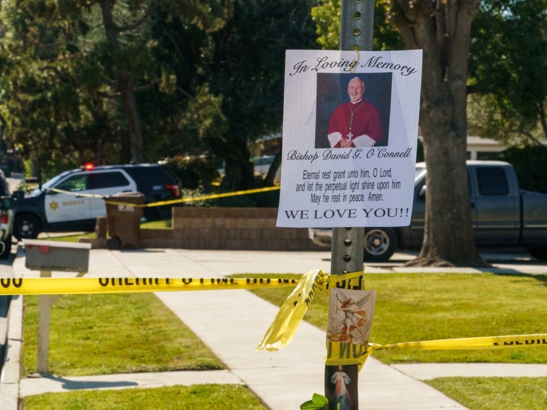 An image of Bishop David O'Connell is posted on the post of a street sign near his home in Hacienda Heights, Calif., Sunday, Feb. 19, 2023. O'Connell was shot and killed Saturday just blocks from a church.