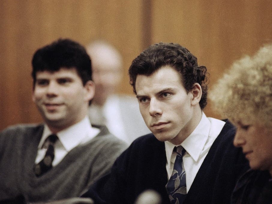 Lyle, left, and Erik Menendez sit with defense attorney Leslie Abramson, right, in the Municipal Court in the Beverly Hills area of Los Angeles, during a hearing, Nov. 26, 1990. 