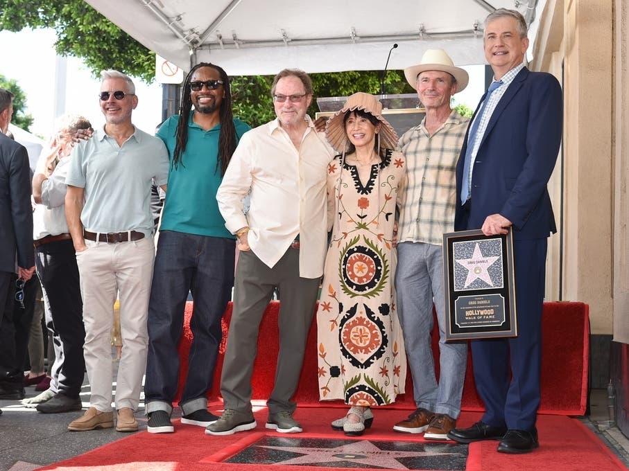 Richard Appel, from left, Saladin K. Patterson, Stephen Root, Lauren Tom, Toby Huss, and Greg Daniels pose with Daniels' new star during a ceremony honoring Daniels on the Hollywood Walk of Fame on Thursday, Sept. 10, 2026, in Los Angeles.