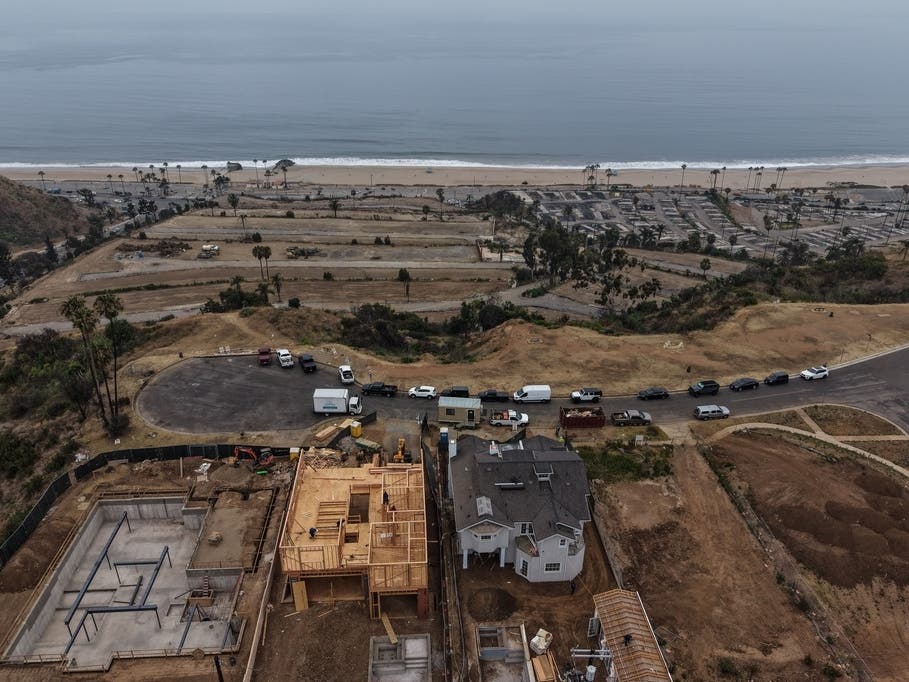 Homes under construction sit on a hillside overlooking the Pacific Ocean more than a year after the Palisades Fire in the Pacific Palisades neighborhood of Los Angeles, Thursday, June 4, 2026.