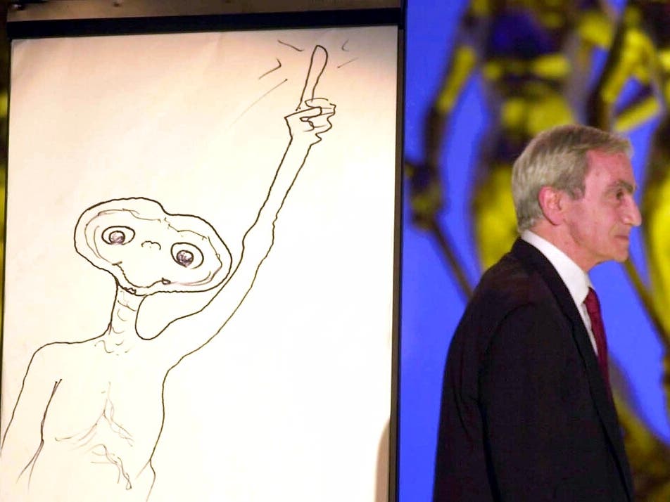 This April 10, 2002 file photo shows special effects artist Carlo Rambaldi walking on stage after drawing a cartoon of ET at an Italian awards ceremony.