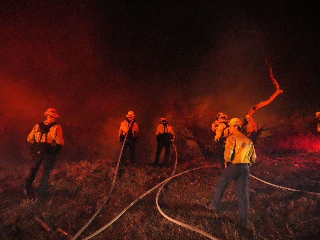 Crews make a stand in front of the Bryson Fire on Thursday, Oct. 15, 2026, in Malibu.