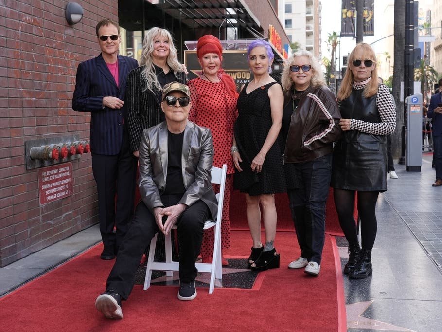 Members of the B-52s, from left, Keith Strickland, Cindy Wilson, Fred Schneider, seated, and Kate Pierson pose with members of the Go-Go's, Jane Wiedlin, Gina Schock, second right, and Charlotte Caffey, right, during Thursday's ceremony.