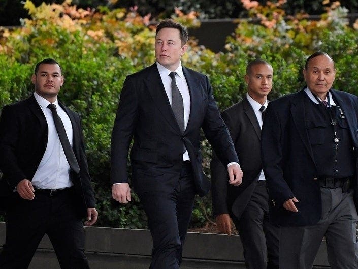 Tesla CEO Elon Musk, second from left, arrives at U.S. District Court Wednesday, Dec. 4, 2019, in Los Angeles.