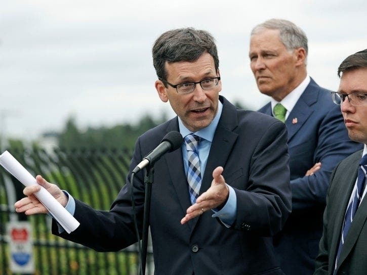 Washington state Attorney General Bob Ferguson in June 2018 with Gov. Jay Inslee and Solicitor Noah Purcell in SeaTac.