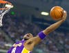 In this May 13, 2001 file photo Los Angeles Lakers' Kobe Bryant reaches back for a rebound during the first half of game four of the Western Conference semifinals against the Sacramento Kings in Sacramento, Calif.
