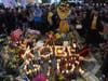 People gather at a memorial near Staples Center after the death of Laker legend Kobe Bryant Sunday, Jan. 26, 2020, in Los Angeles.
