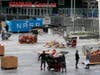 Workers remove thousands of items left in honor of Kobe Bryant, including hundreds of basketballs, from X-Box Plaza across Chick Hearn Court from Staples Center, home of the Los Angeles Lakers, early Monday, Feb. 3, 2020, in Los Angeles.