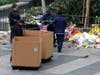Workers remove thousands of items left in honor of Kobe Bryant, including hundreds of basketballs, from X-Box Plaza across Chick Hearn Court from Staples Center, home of the Los Angeles Lakers, early Monday, Feb. 3, 2020, in Los Angeles.