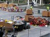 Workers remove thousands of items left in honor of Kobe Bryant, including hundreds of basketballs, from X-Box Plaza across Chick Hearn Court from Staples Center, home of the Los Angeles Lakers, early Monday, Feb. 3, 2020, in Los Angeles.
