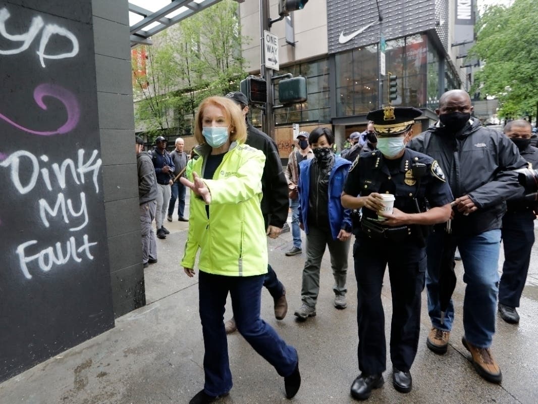 Seattle Mayor Jenny Durkan, left, surveys downtown Seattle with Police Chief Carmen Best on Sunday, May 31, 2020, following protests the night before.