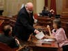 In this Friday, June 12, 2020, photo, Democratic state Sens. Mike McGuire, of Healdsburg, left, Jim Beal, of San Jose, center, and Nancy Skinner, of Oakland, members of the Senate Budget Committee, huddle after a hearing on the state budget in Sacramento.