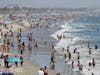 Visitors crowd the beach Sunday, July 12, 2020, in Santa Monica, Calif., amid the coronavirus pandemic. A heat wave has brought crowds to California's beaches as the state grappled with a spike in coronavirus infections and hospitalizations.