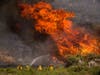 Firefighters work against the Apple Fire near Banning, Calif., Sunday, Aug. 2, 2020.