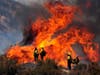 Firefighters watch the Apple Fire in Banning, Calif., Sunday, Aug. 2, 2020.