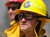 A firefighter watches the Apple Fire in Banning, Calif., Sunday, Aug. 2, 2020.
