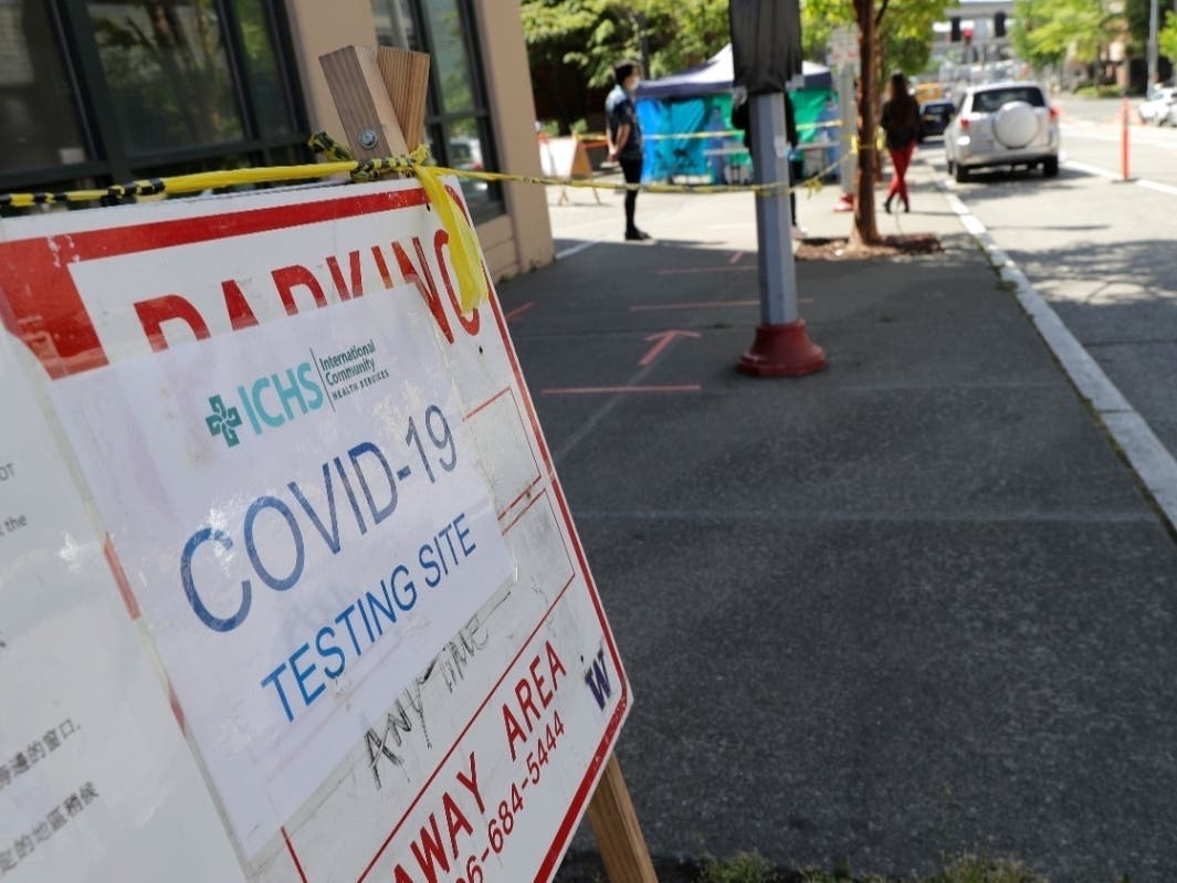 A sign at the International Community Health Services clinic in Seattle's International District, points the way to a drive-up and walk-up testing site for COVID-19, Friday, May 15, 2020.