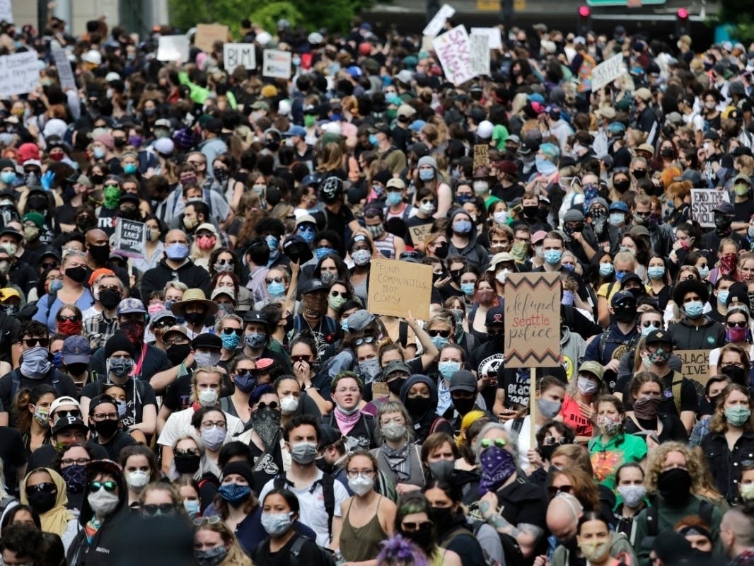 Peaceful protesters fill a street adjacent to Seattle City Hall Wednesday, June 3, 2020, in Seattle.