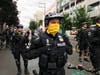 Seattle police stand on a road in the Capitol Hill Organized Protest zone early Wednesday, July 1, 2020. Police in Seattle have torn down demonstrators' tents in the city's occupied protest zone after the mayor ordered it cleared. 