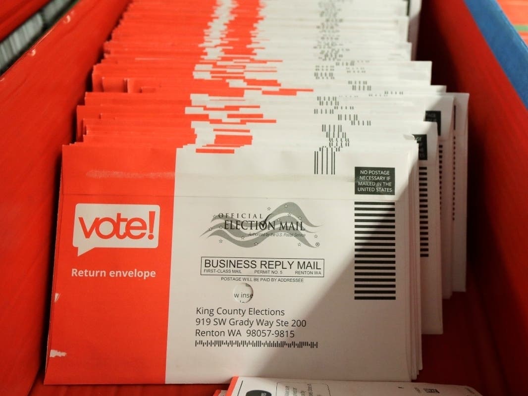 Vote-by-mail ballots are shown in a sorting tray, Wednesday, Aug. 5, 2020, at the King County Elections headquarters in Renton, Wash.