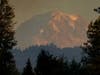 A flock of birds flies above Mount Rainier as smoke from burning wildfires creates a hazy view, Tuesday, Sept. 8, 2020, near Sumner, Wash., south of Seattle.