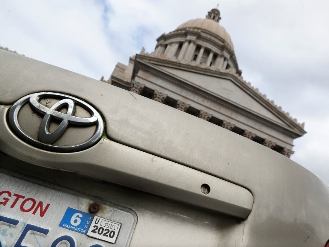 A car registration tab is shown on a vehicle parked at the Capitol, Wednesday, Feb. 12, 2020, in Olympia, Wash.