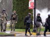 Armed protesters walk on the Capitol campus Monday, Jan. 11, 2021, in Olympia, Wash. According to organizers, some protesters are unhappy the Legislature will be meeting virtually and in sessions not open to the public, due to the COVID-19 pandemic.