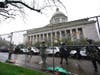 Members of the Washington National Guard stand near a fence surrounding the Capitol in anticipation of protests Monday, Jan. 11, 2021, in Olympia, Wash.