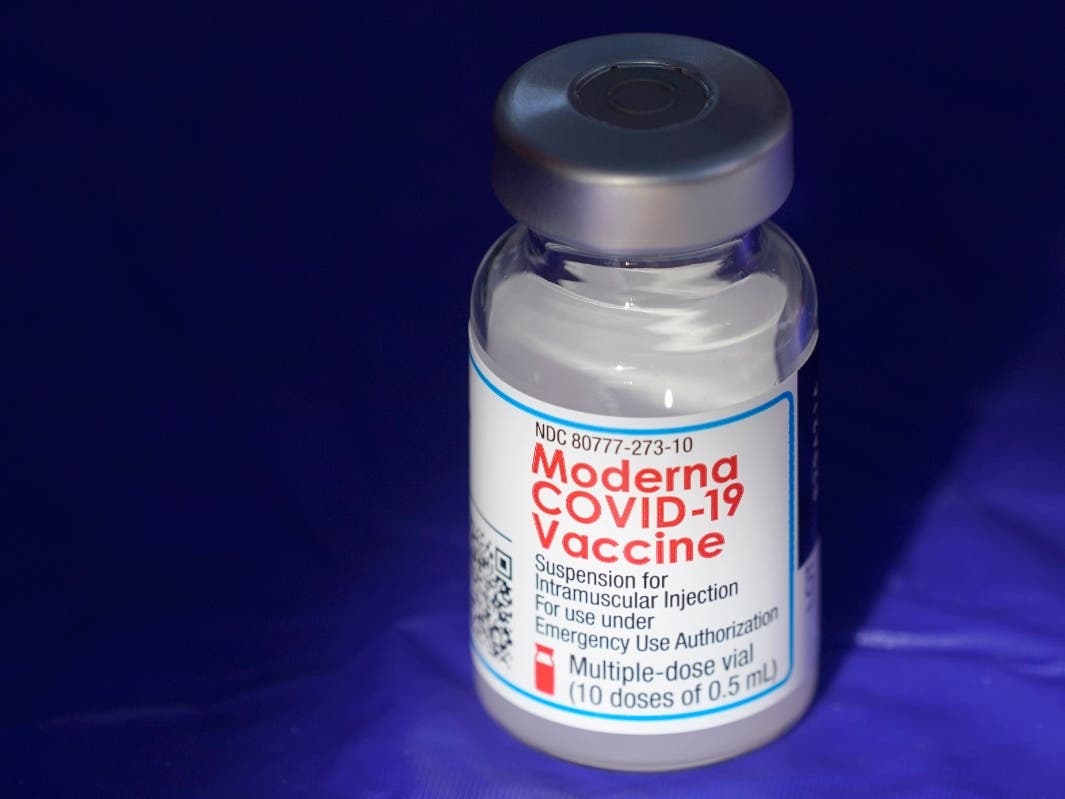 A vial of the Moderna COVID-19 vaccine rests on a table, Thursday, March 4, 2021, at a drive-up mass vaccination site in Puyallup, Wash., south of Seattle.
