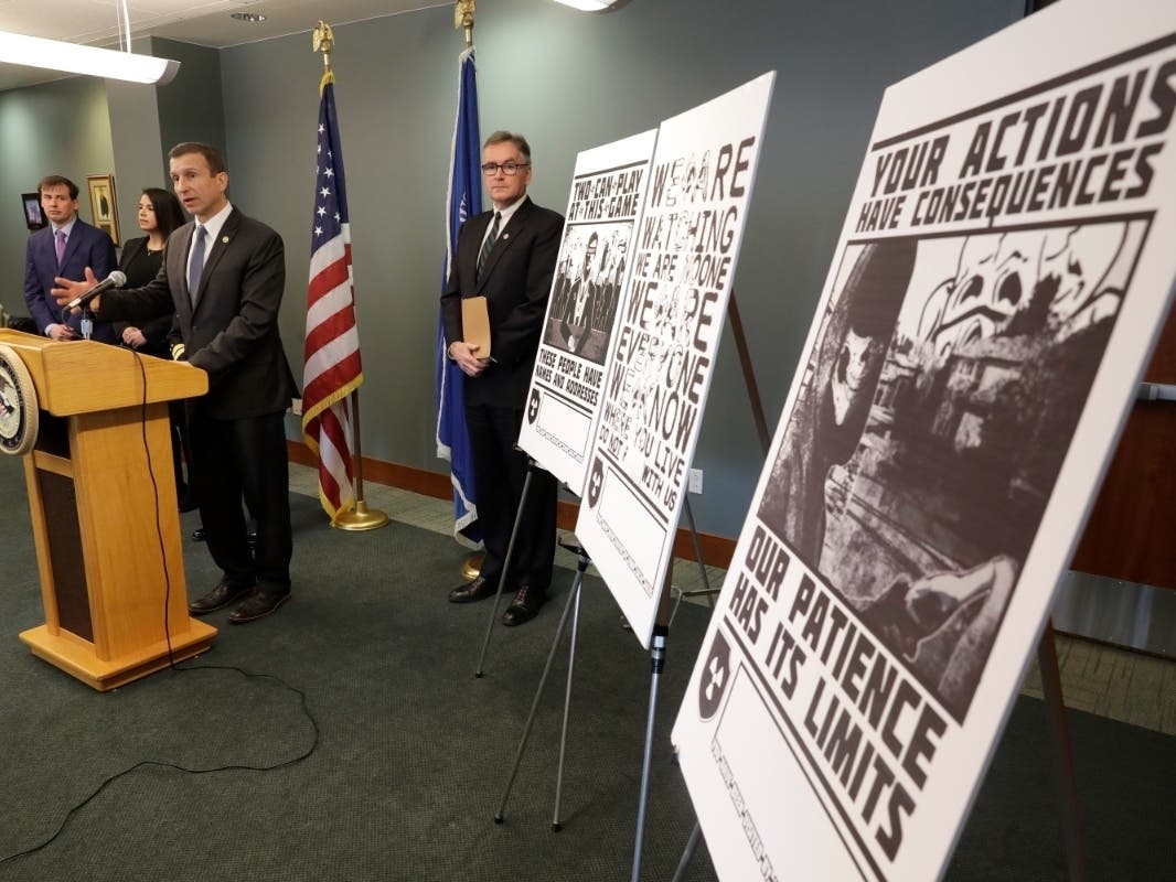 In this Feb. 26, 2020, file photo, Raymond Duda, FBI Special Agent in Charge in Seattle, speaks during a news conference at a podium, about charges against a group of alleged members of the neo-Nazi group Atomwaffen Division.