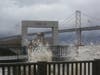 People watch large waves along The Embarcadero near Pier 14 between Mission Street and Howard Street in San Francisco on Tuesday, March 21, 2023.