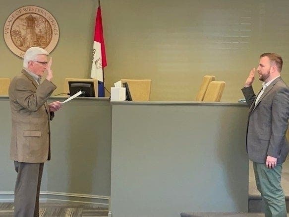 Western Springs Village Clerk James Horvath swears in Casey Biernacki as the new deputy village manager May 10. The Village Board did not approve the appointment, as required under the village code. Western Springs Village Clerk James Horvath swears in Ca