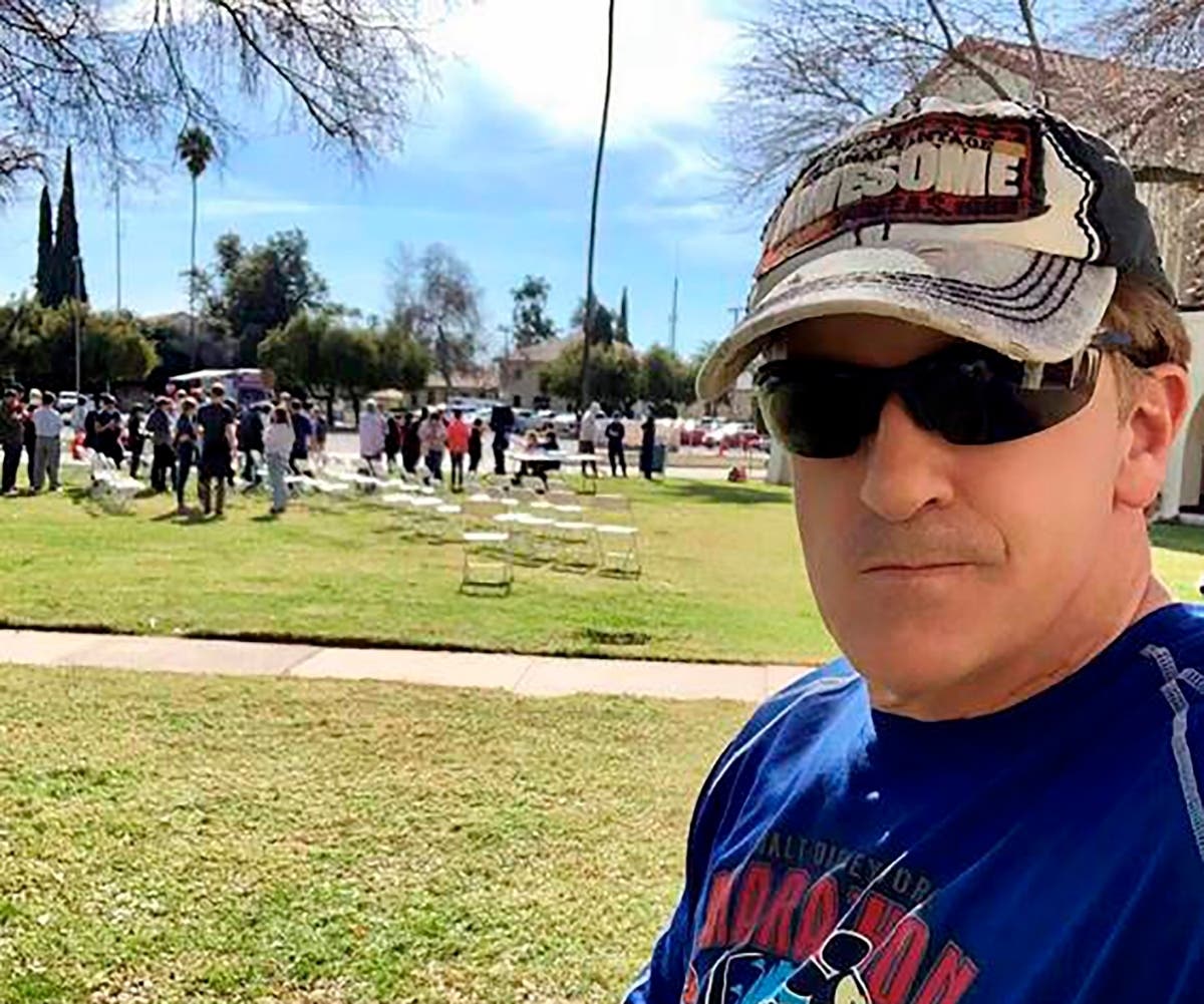 This Feb. 5, 2020 self-portrait by Matthew McCoy with some of nearly 200 fellow coronavirus evacuees from China (background) where they are being quarantined at March Air Reserve Base in Riverside, Calif. 