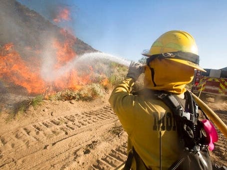 A firefighter battles the Apple Fire in Banning, Calif., Sunday, Aug. 2, 2020.