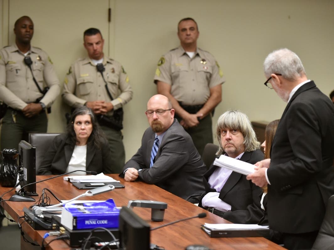 Louise Anna Turpin, left, with her attorney, second from left, and her husband David Allen Turpin, listen to attorney, David Macher, as they appear in court for their Jan. 18 arraignment. They were each sentenced to 25 years to life in state prison.