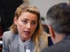 Actor Amber Heard speaks to her legal team at the Fairfax County Circuit Courthouse on Friday. Actor Johnny Depp sued his ex-wife after she wrote an op-ed piece in 2018 referring to herself as a "public figure representing domestic abuse."