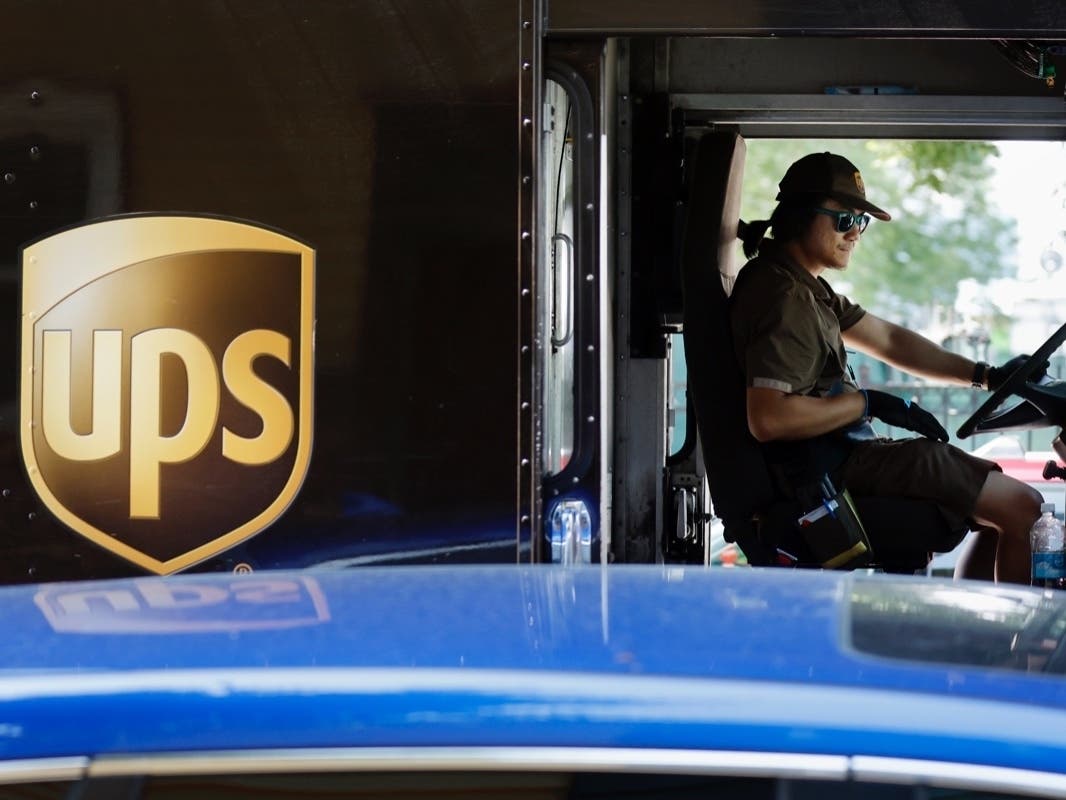 United Parcel Service driver Hudson de Almeida steers through a neighborhood while delivering packages, Friday, June 30, in Haverhill, Massachusetts.