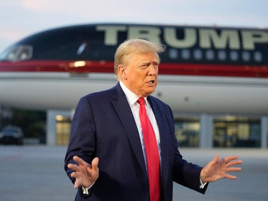 Former President Donald Trump speaks with reporters before departure from Hartsfield-Jackson Atlanta International Airport, Aug. 24, 2023, in Atlanta. 