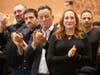 Bruce Springsteen, center, and Patti Scialfa, right, applaud as their son Sam Springsteen is sworn in as a Jersey City firefighter Tuesday.