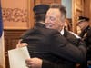Bruce Springsteen hugs his son Sam Springsteen after he is sworn in as a Jersey City Firefighter at City Hall in Jersey City on Jan. 14, 2020.