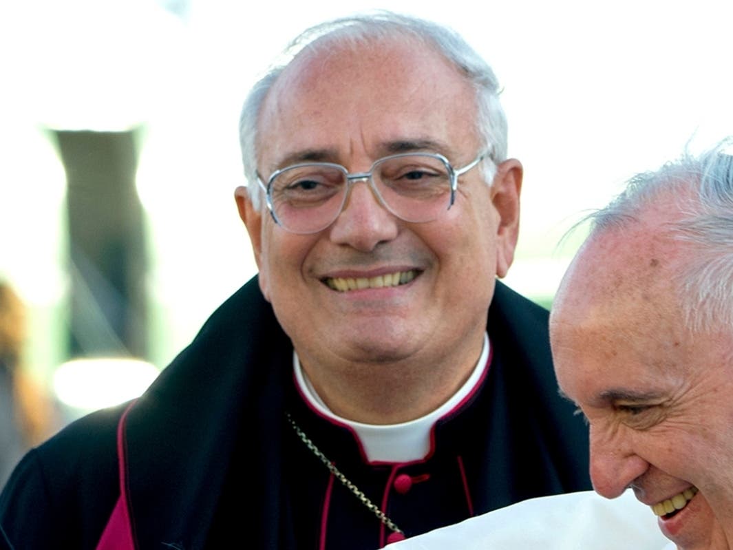 This Thursday, Sept. 24, 2015 file photo shows Brooklyn Bishop Nicholas DiMarzio as Pope Francis, right, arrives at John F. Kennedy International Airport in New York. 