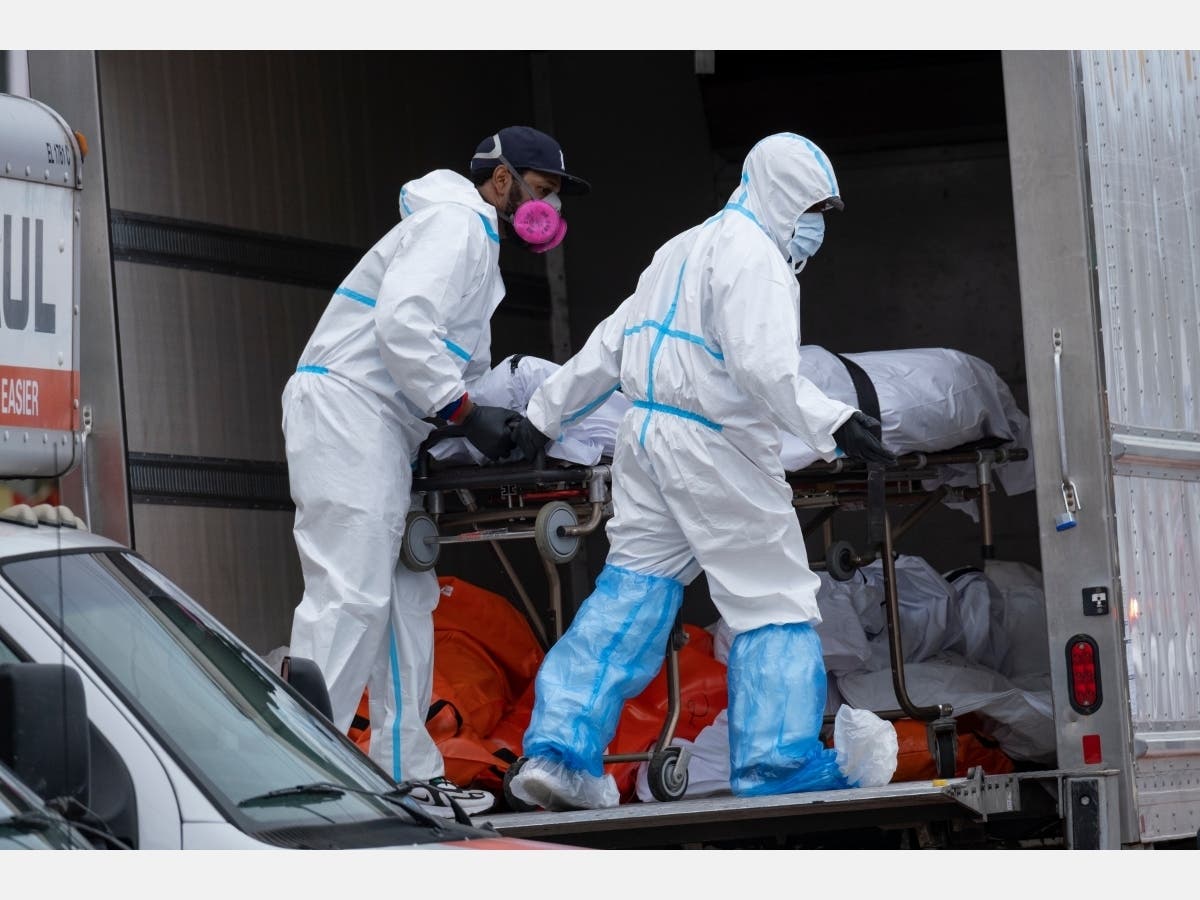 Authorities moved bodies found stored in a rented truck outside a Flatlands funeral home Wednesday to refrigerated storage.