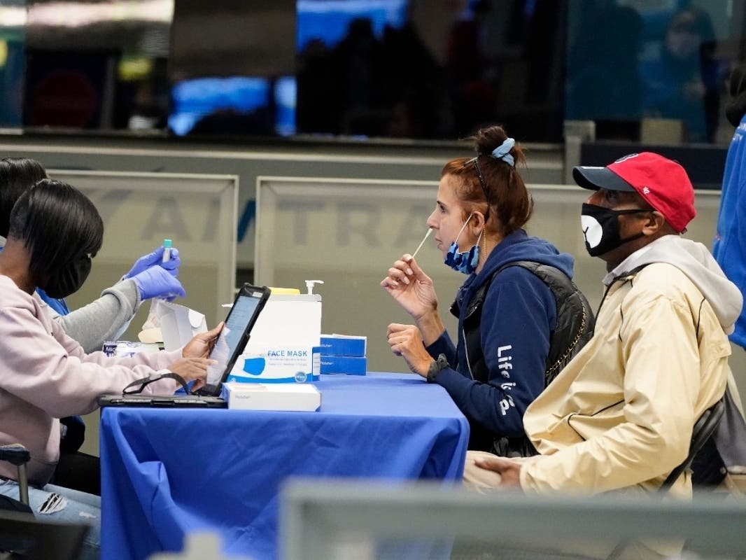 Travelers self test for COVID-19 at a NYC Health + Hospitals mobile testing site Nov. 24 in New York's Penn Station. 