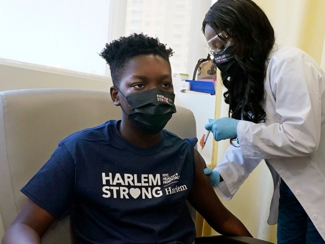 Julian Boyce, 14, receives his first Pfizer COVID-19 vaccination at NYC Health + Hospitals/Harlem, from nurse Kenia Georges on May 13.
