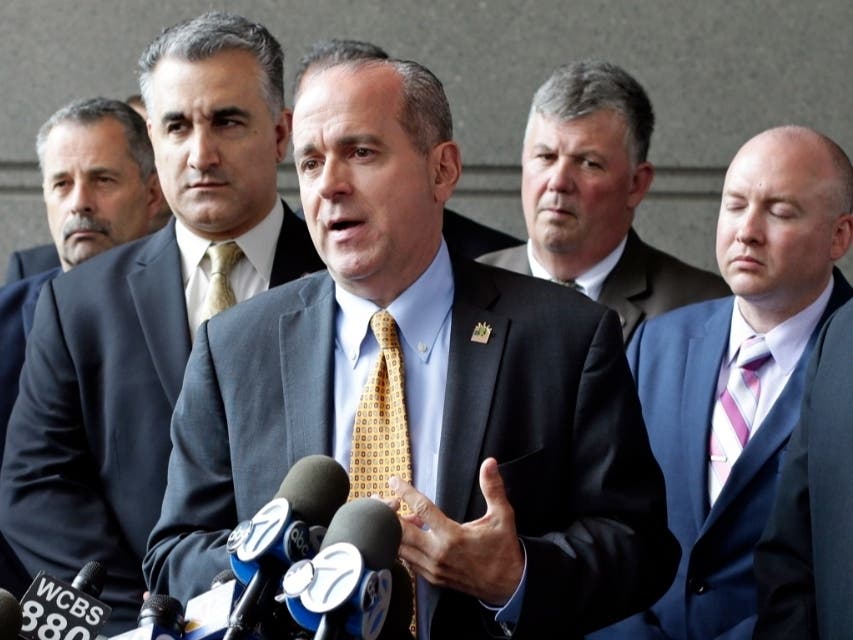 In this May 31, 2017, file photo, Sgt. Ed Mullins, the head of the Sergeants Benevolent Association, center, speaks to the media outside of the Bronx Supreme Court in the Bronx borough of New York.