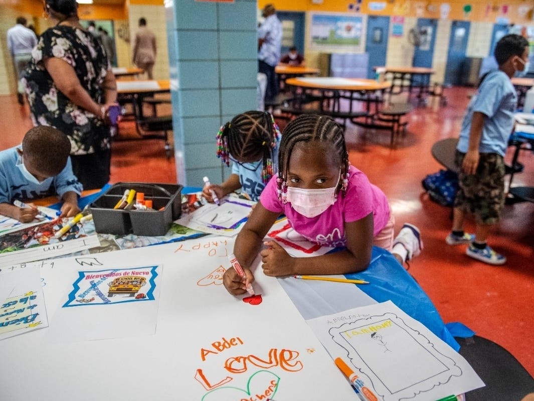 Students write and draw positive affirmations on poster board at P.S. 5 Port Morris, an elementary school in the Bronx on Aug. 17.