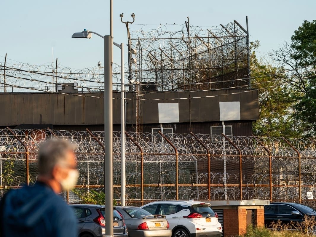 A security fence surrounds inmate housing at the Rikers Island correctional facility on Sept. 27.