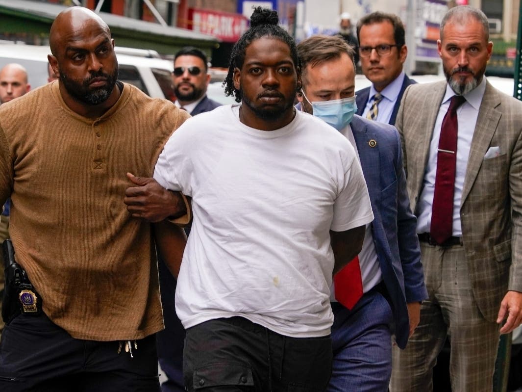 Andrew Abdullah is escorted into the NYPD's 5th Precinct on Tuesday.